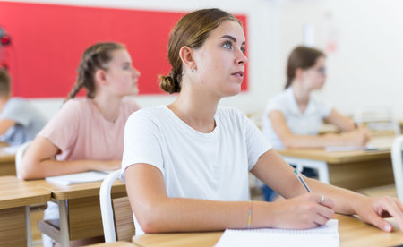 Teenager students sitting at desks