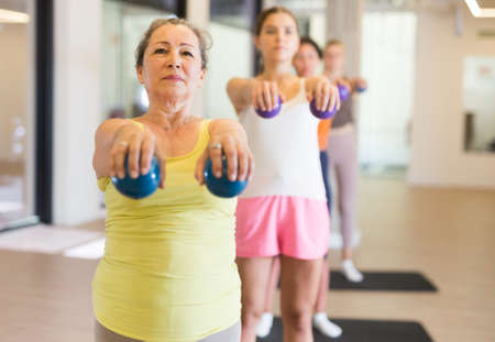 Aerobics pilates women with toning balls in row on fitness classの写真素材