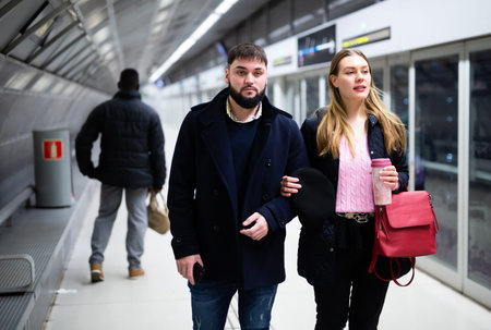 Couple waiting for subway train