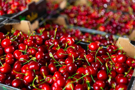 Fresh cherry on counter in supermarketの写真素材