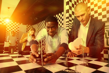 Four friends looking for way out of chess quest room