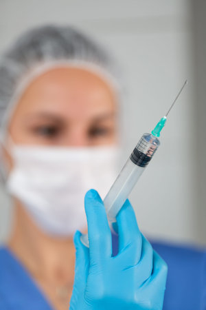 Nurse with vaccine. Nurse are showing syringe of vaccine