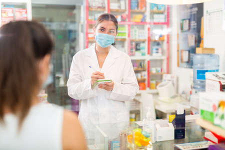 Pharmacist talking with clientの写真素材