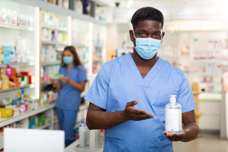 Pharmacist with bottle of liquid soapの写真素材