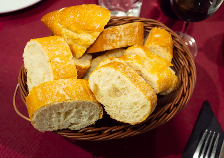 Bread served on table with glass of red wine