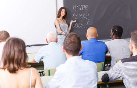 Serious female lecturer talking to studentsの写真素材