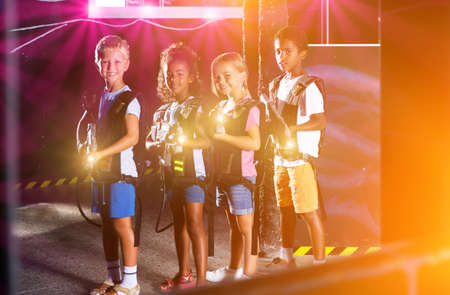 Group of cheery tweenagers with laser gunsの写真素材