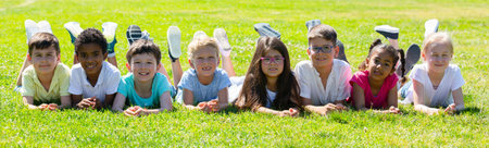 Portrait of children who are posing lying in the park