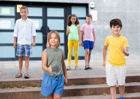 Confident tweens walking along city street on summer dayの写真素材