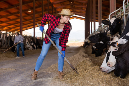 Portrait of woman farmer working in cowshed
