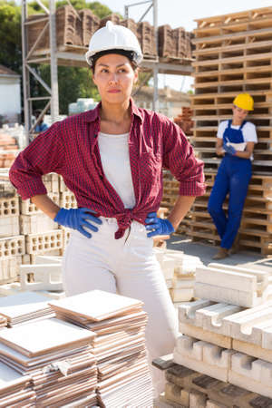 Female workers standing in outdoor storageの写真素材