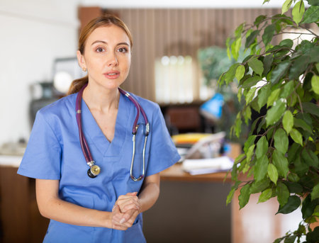 Nurse standing in hall of clinic