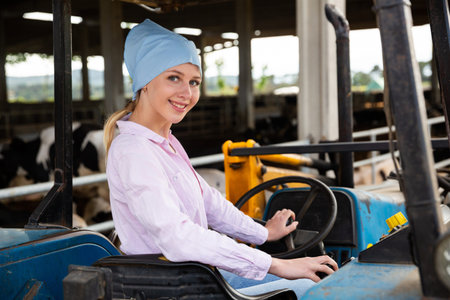 Young woman proffesional farmer is sitting in the car at the farm