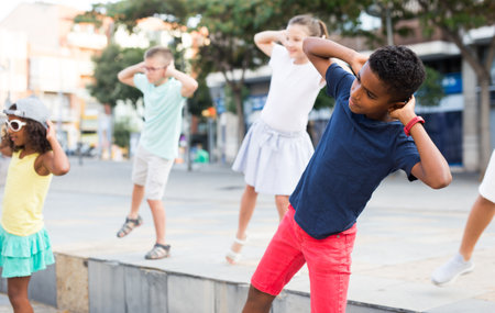 Young boys and girls dancing outdoorsの写真素材
