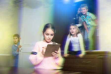 Focused tween girl solving conundrum to get out of quest room, toned imageの写真素材