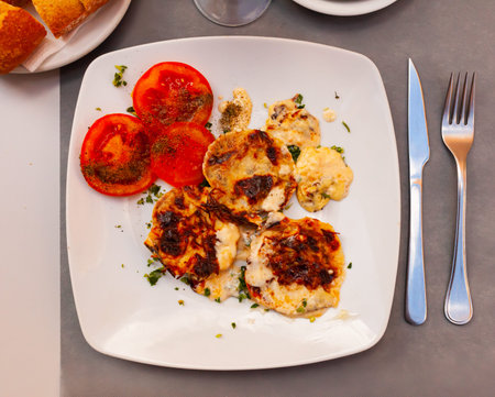 Delicious stuffed scallops with tomatoes closeup