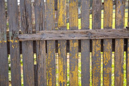 Rustic old wooden fence with rotten planksの写真素材