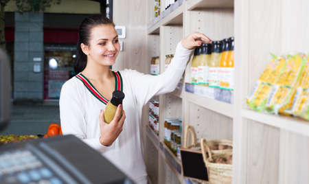 Woman choosing juice in shopの写真素材