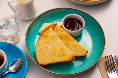 Breakfast. Croutons with cheese and jam on table