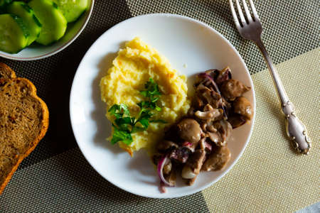 Mushrooms with mashed potatoes on white plateの写真素材