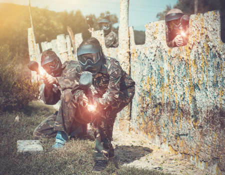 Paintball team running with marker gunsの写真素材