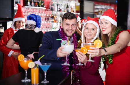 Man with females on corporate new year party in barの写真素材
