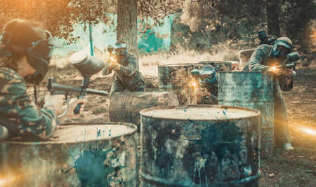 enthusiastic teams facing on battlefield in outdoor paintball arの写真素材