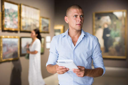 Portrait of man in galleryの写真素材