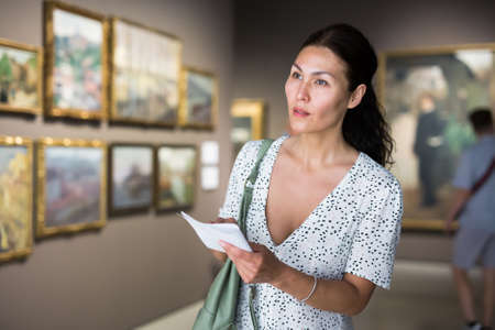 woman admiring art workの写真素材