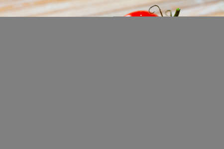 Two red tomatoes on wooden tableの写真素材