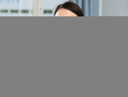 Girl in satin robe posing in living roomの写真素材