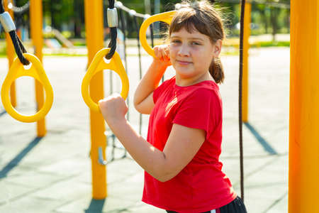 Smiling girl on outdoor playgroundの写真素材