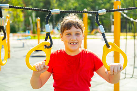 Smiling girl on outdoor playgroundの写真素材