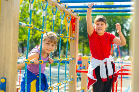 Portraits of two teenage girls on the playgroundの写真素材