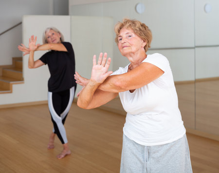 Mature active women practice vigorous swingの写真素材