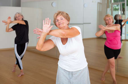 Mature active women practice vigorous swingの写真素材