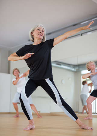 Mature women performing ballet dance in exercise roomの写真素材