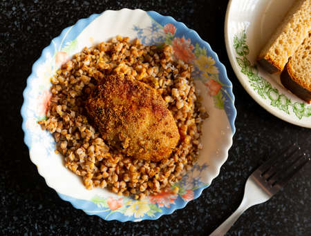 Appetizing buckwheat porridge with cutlet on plate. Healthy food. Russian cuisineの写真素材