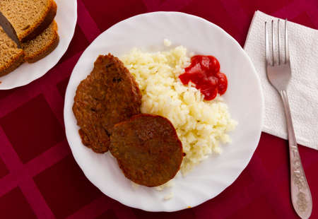 Traditional dish of Russian cuisine is cutlets with riceの写真素材