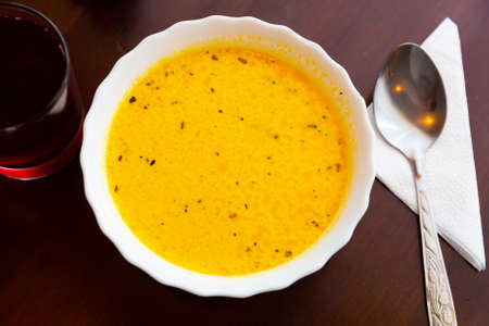 Traditional Russian dish - cheese spice soup on wooden tableの写真素材