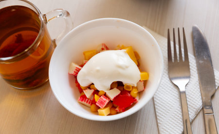 Salad with corn, pepper, crab, cheese and sour cream. Russian cuisineの写真素材
