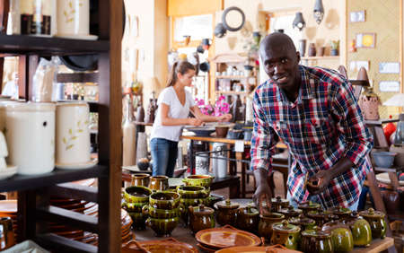 Male customer visiting pottery shopの写真素材