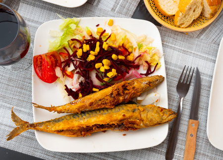 Grilled mackerel fillet served with vegetables and corn grains
