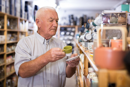 Mature man choosing new dishes at store