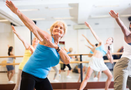 Portrait of an mature European woman enjoying energetic dancing in the studioの写真素材