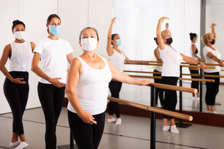 Group of multiethnic female dancers training in masks during COVID-19 pandemicの写真素材