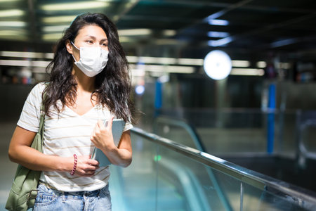Woman in face mask walking in mall