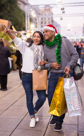 Portrait of couple points to toys at street marketの写真素材