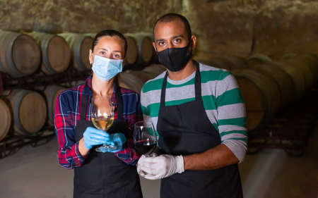 Two winemakers posing with wine in glassesの写真素材