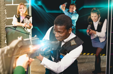 Afro businessman playing laser tag